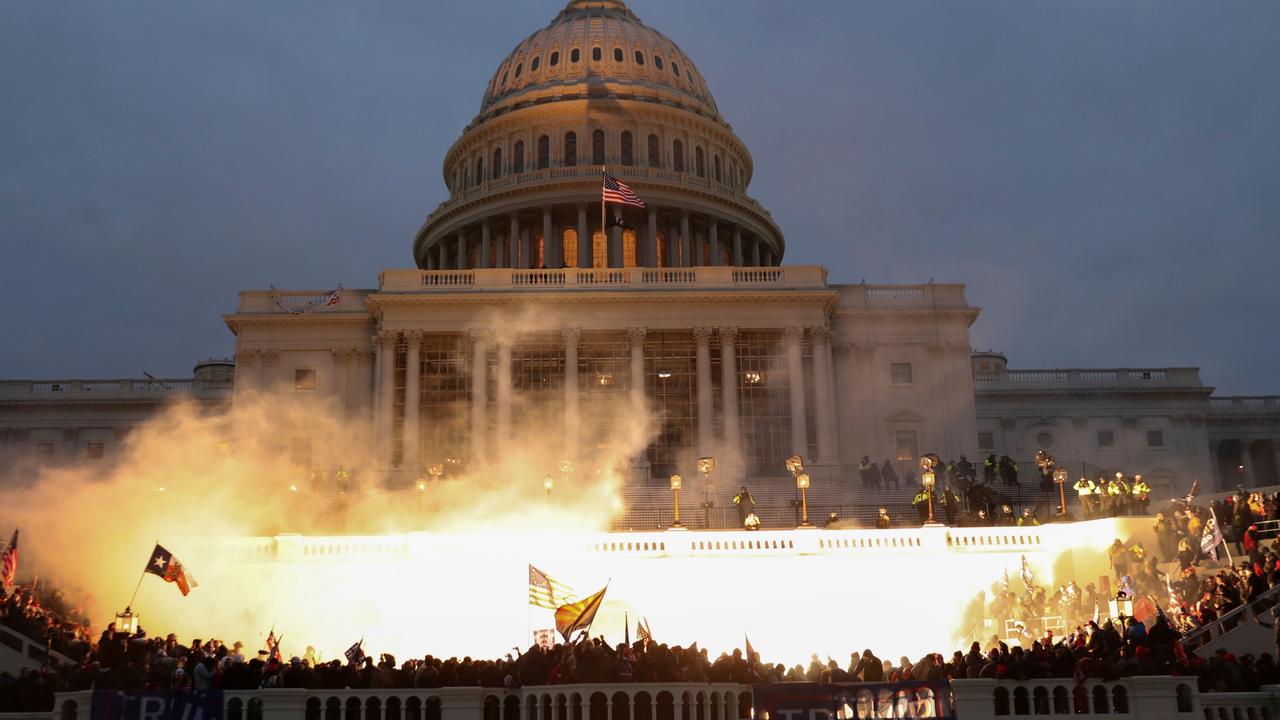 An explosion caused by a police munition is seen while Trump supporters gather in front of the Capitol Building. Picture: Leah Millis/Reuters