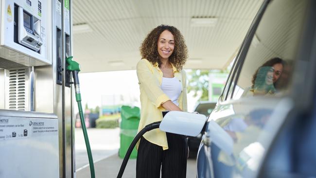 Why is she smiling? Paying $2-plus for fuel is now normal, and taxes will jump soon.