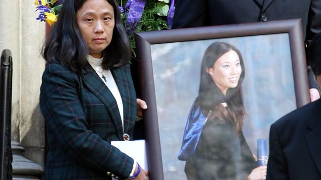 Miss Oliver’s mother, Priscilla, walks with a photo of her daughter after her funeral in 2007.