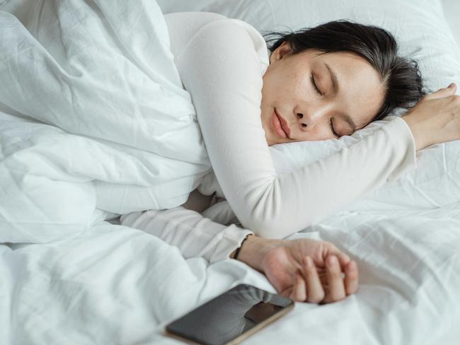 Stock image of a woman sleeping on her side.