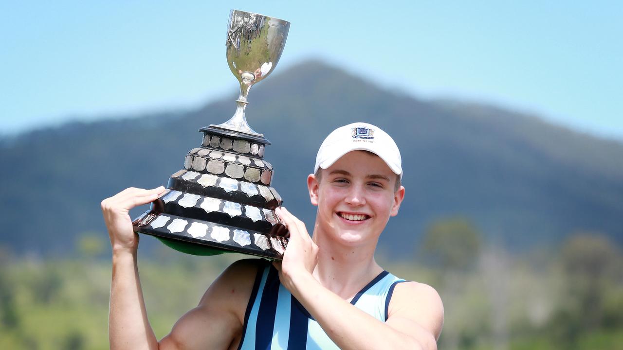 Brisbane Grammar School rowing captain Hugh Weightman hoists the O’Connor Cup after his crew won the GPS Head of the River on Saturday. Picture: AAP