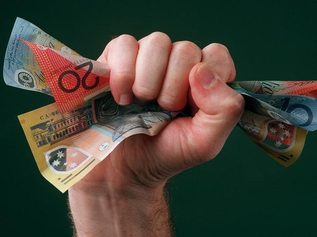 Undated : Fist full (fistful) of dollars. Pic Rob Baird. Money Note Notes $10 $20 $50 australian currency Picture: Supplied