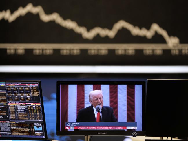 US President Donald Trump appears on a television screen at the stock market in Frankfurt, Germany, Thursday, April 3, 2025. (AP Photo/Michael Probst)