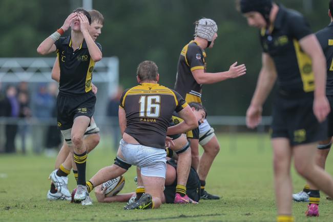 St Laurence’s scrumhalf Josh Madden (left) wore his heart on his sleeve and box kicked well in the wet.