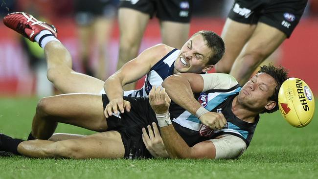 Port Adelaide’s Steven Motlop tackled by Geelong’s Tom Atkins. Picture: Matt Roberts/Getty