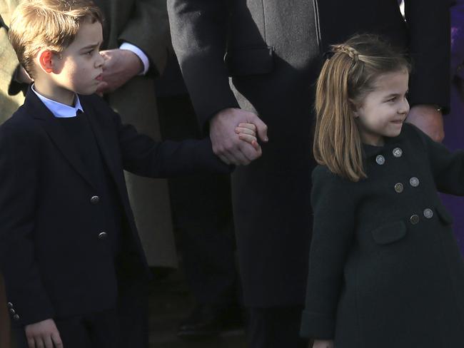 Britain's Prince William, Duke of Cambridge and Catherine, Duchess of Cambridge hold the hands of their children Prince George and Princess Charlotte after attending a Christmas day service at the St Mary Magdalene Church in Sandringham in Norfolk, England, Wednesday, Dec. 25, 2019. (AP Photo/Jon Super)