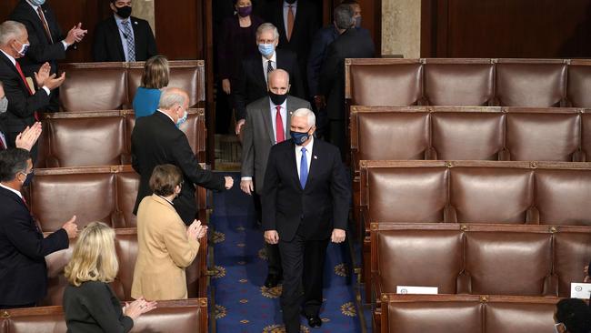 Vice President Mike Pence arrives at the House Chamber before a joint session of congress in Washington.