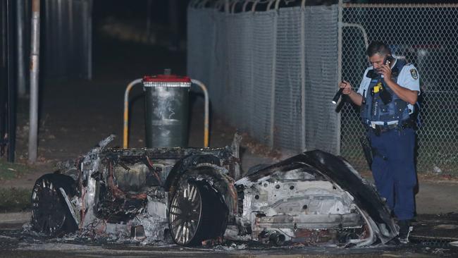 An Audi sports car used in the shooting at Lomond St, Guildford West, was dumped and set on fire at Merrylands Park. Picture: Bill Hearne