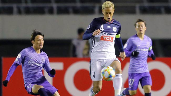 Keisuke Honda takes on the Hiroshima defence. Picture: AFP