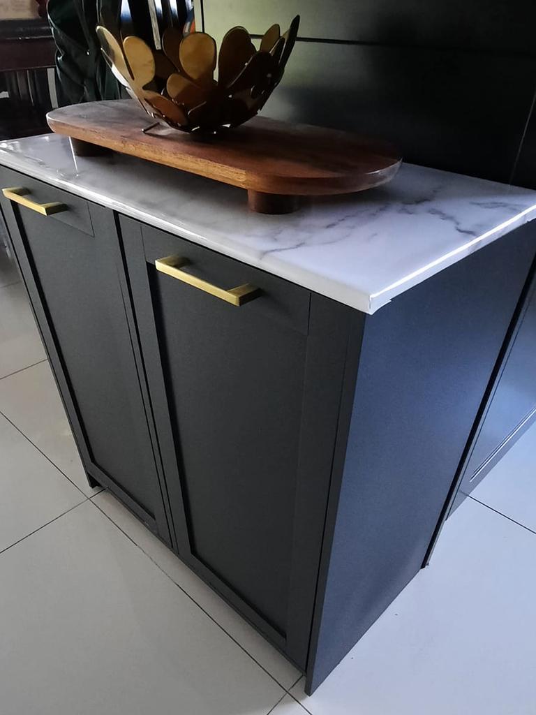 One woman completely redesigned the hamper so it blended in with her kitchen bench, popping it to sit under the tabletop. Picture: Facebook/Kmart Hacks &amp; Decor