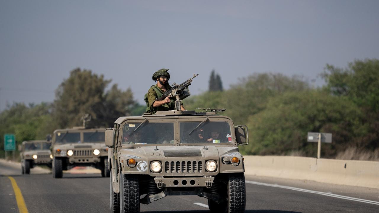 A convoy of Israel Defense Forces soldiers drives along a road near the outskirts of Netivot and near an Artillery position.