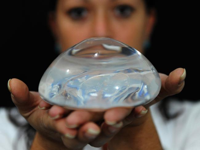 A woman shows a French mammary implant in Caracas, where big breasts and French silicone are all the rage among beauty queens, fashion models and thousands of anonymous women, despite the economic crisis.