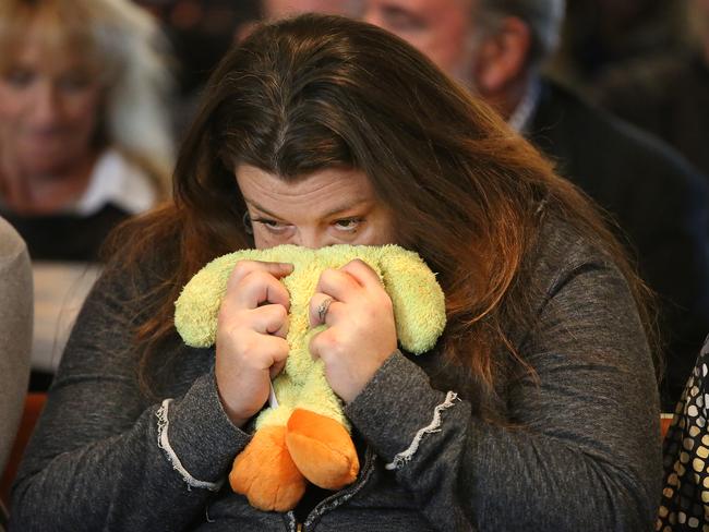 Megan Fewtrell, godmother of Bella Bond, clutches "Ducky," Bella's favourite stuffed animal that was kept at Fewtrell's home. Picture: Pat Greenhouse