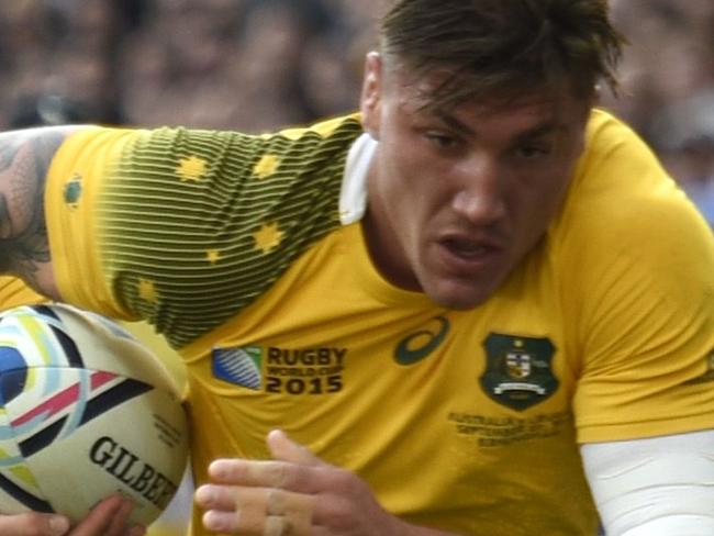 Australia's flanker Sean McMahon (R) runs in Australia's first try during the Pool A match of the 2015 Rugby World Cup between Australia and Uruguay at Villa Park in Birmingham, north England on September 27, 2015. AFP PHOTO / MARTIN BUREAU RESTRICTED TO EDITORIAL USE, NO USE IN LIVE MATCH TRACKING SERVICES, TO BE USED AS NON-SEQUENTIAL STILLS