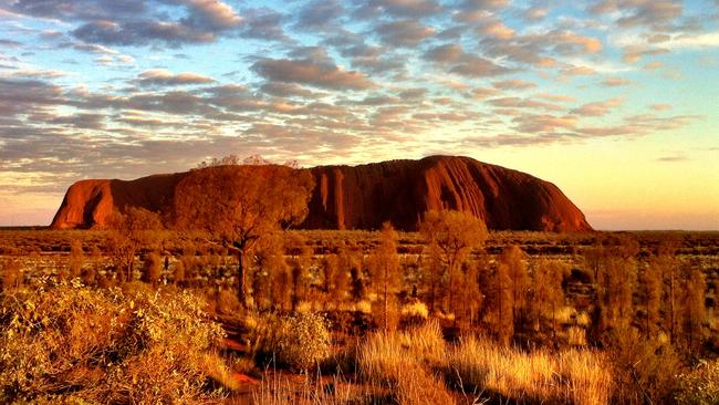 Uluru, seen here at sunrise, was handed over after a 10-year debate.