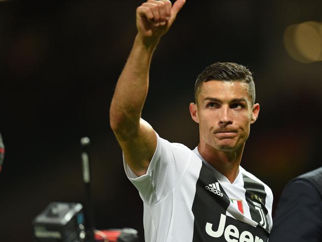 Juventus' Portuguese striker Cristiano Ronaldo gestures to supporters on the pitch after the Champions League group H football match between Manchester United and Juventus at Old Trafford in Manchester, north west England, on October 23, 2018. - Juventus won the game 1-0. (Photo by Oli SCARFF / AFP)