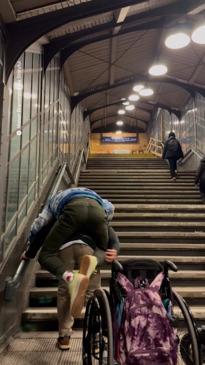 Father is praised after carrying paralysed son up three flights of stairs