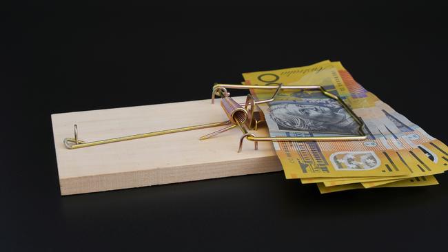 Rat trap on black background, trapping bank notes, conceptual use for business, risk, loans, financial trouble, with copy space. Debt Australian money generic