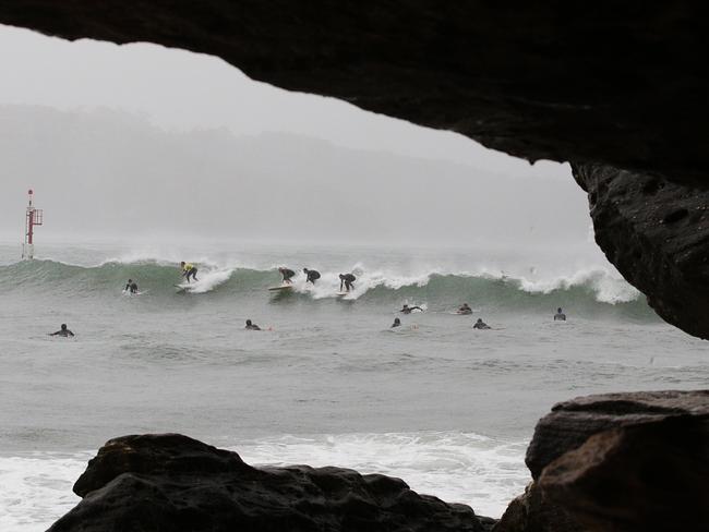 Surfers riding rare waves in Sydney Harbour off Nielsen Park, Vaucluse. Picture: Danny Aarons.