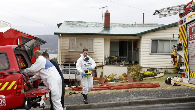 Members of the Tasmanian Police and Tasmania Fire Service attend the scene at Oakbank Ave, Montrose where a fire occurred last night. Picture: Zak Simmonds