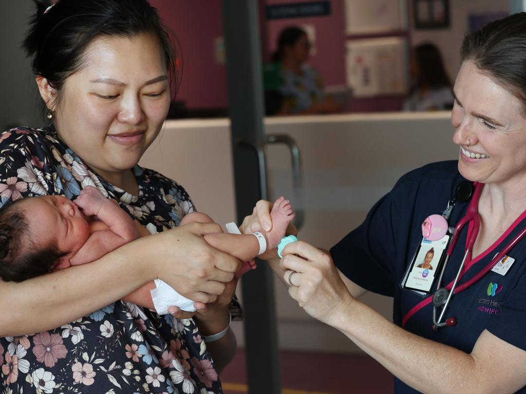 Midwife Kate Moyle does the heel prick test on Sahar Khajavee watched closely by mum Quyen Khajavee. Picture: David Caird