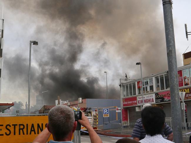 Thick black smoke from the fire is blowing across the west. Picture: Hamish Blair