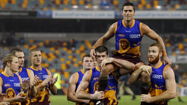 Simon Black is chaired off by Jonathan Brown and Daniel Merrett after his 300th AFL match in 2012