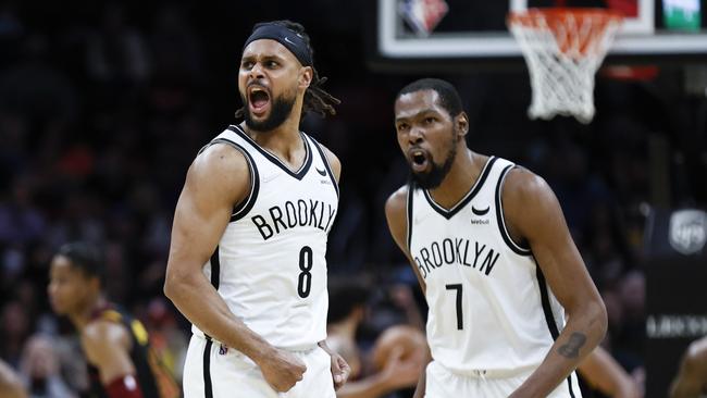 CLEVELAND, OH - NOVEMBER 22: Patty Mills #8 and Kevin Durant #7 of the Brooklyn Nets react after a made shot against the Cleveland Cavaliers during the second half at Rocket Mortgage Fieldhouse on November 22, 2021 in Cleveland, Ohio. The Nets defeated the Cavaliers 117-112. NOTE TO USER: User expressly acknowledges and agrees that, by downloading and or using this photograph, User is consenting to the terms and conditions of the Getty Images License Agreement. Ron Schwane/Getty Images/AFP == FOR NEWSPAPERS, INTERNET, TELCOS & TELEVISION USE ONLY ==