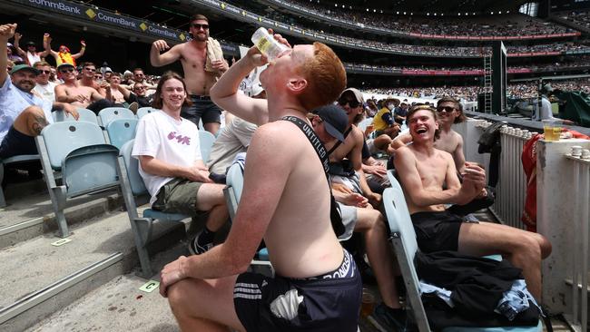 Beer sculling was a favourite game for some fans at the Boxing Day Test. Picture: David Caird