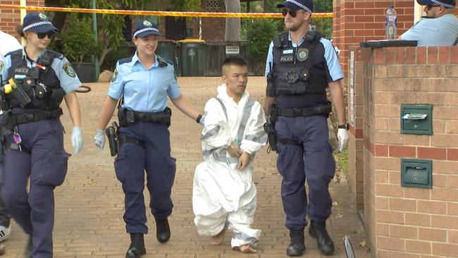 Police arrest a man following the explosion at the Canley Vale home on Thursday. Picture: John Tesoriero