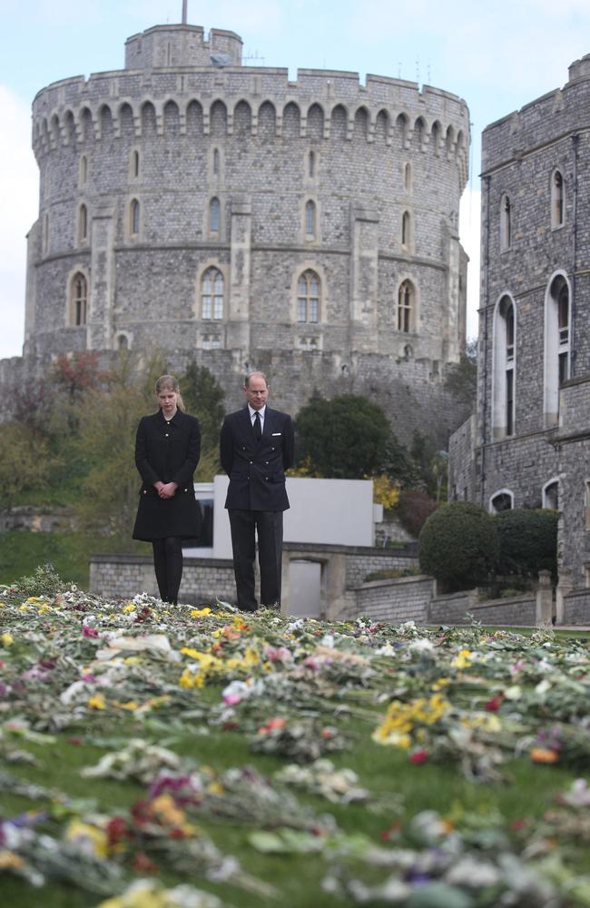 Britain's Prince Edward, Earl of Wessex, and his daughter Britain's Lady Louise Windsor view flowers outside St George's Chapel, at Windsor Castle in Windsor. Picture: AFP