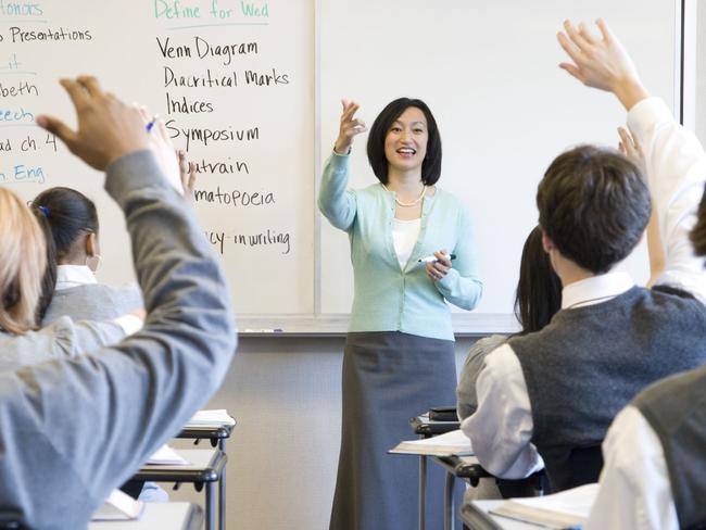 Generic image of teacher teaching students inside school classroom.