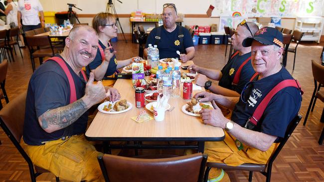 CFS firefighters David Dyer and Bob Sadleir enjoy their Christmas Lunch prepared by the Salvation Army at Gumeracha Oval on Christmas Day. Picture: Mark Brake