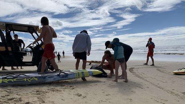 Surf Life Saving Queensland lifeguards assisted by Shane Petersen rescued a woman and boy from rough surf at Alexandra Headland on Sunday morning. Picture: Stuart Cumming.