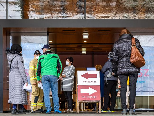 People stand in line in front of the vaccination and testing centre in Schwaz, Austria, at the start of the vaccination campaign. Picture: APA / AFP / Austria OUT