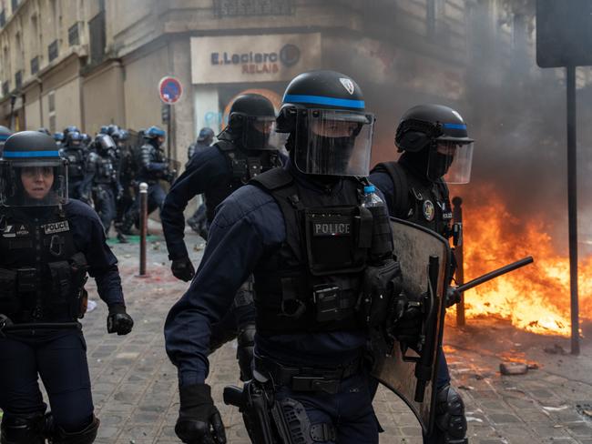 Police officers charge protesters during a rally against pension reforms in Paris, France. Picture: Getty Images