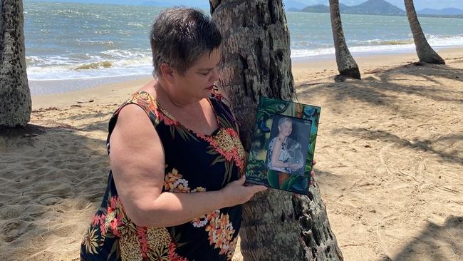 Sandy Davies poses with a photograph of her mother at Palm Cove. Picture: Sandy Davies.