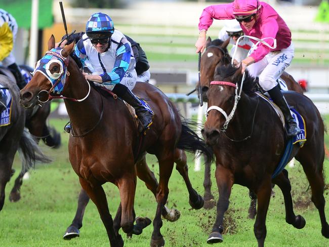 Kenedna (left) on her way to winning the Doomben Roses on Saturday. Picture: Grant Peters, Trackside Photography