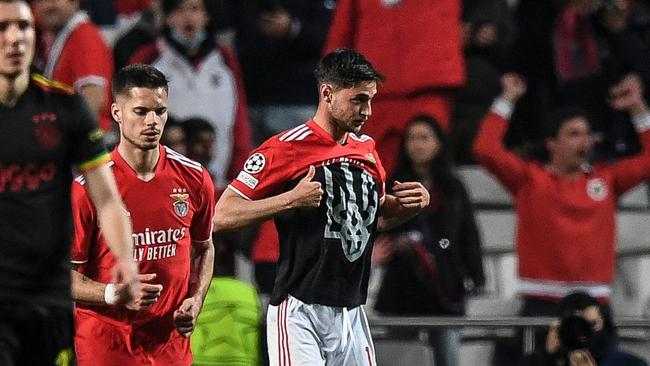 Benfica's Ukrainian forward Roman Yaremchuk reveals a shirt bearing his country's coat of arms, as he celebrates after scoring a goal during a UEFA Champions League football match. Picture: Patricia de Melo Moreira / AFP)