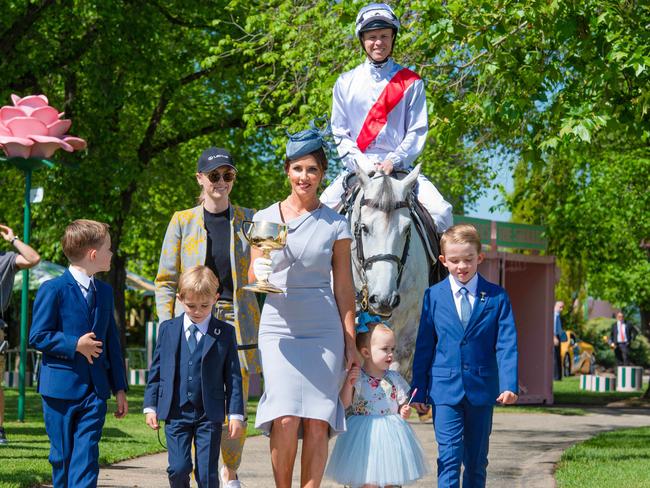 2019 Melbourne Cup Carnival Launch at The Park, Flemington. Kerrin & Cathy McEvoy - Lexus Melbourne Cup Tour ambassadors with kids and the 1919 Melbourne Cup, first of the 3 handled design. Picture: Jason Edwards