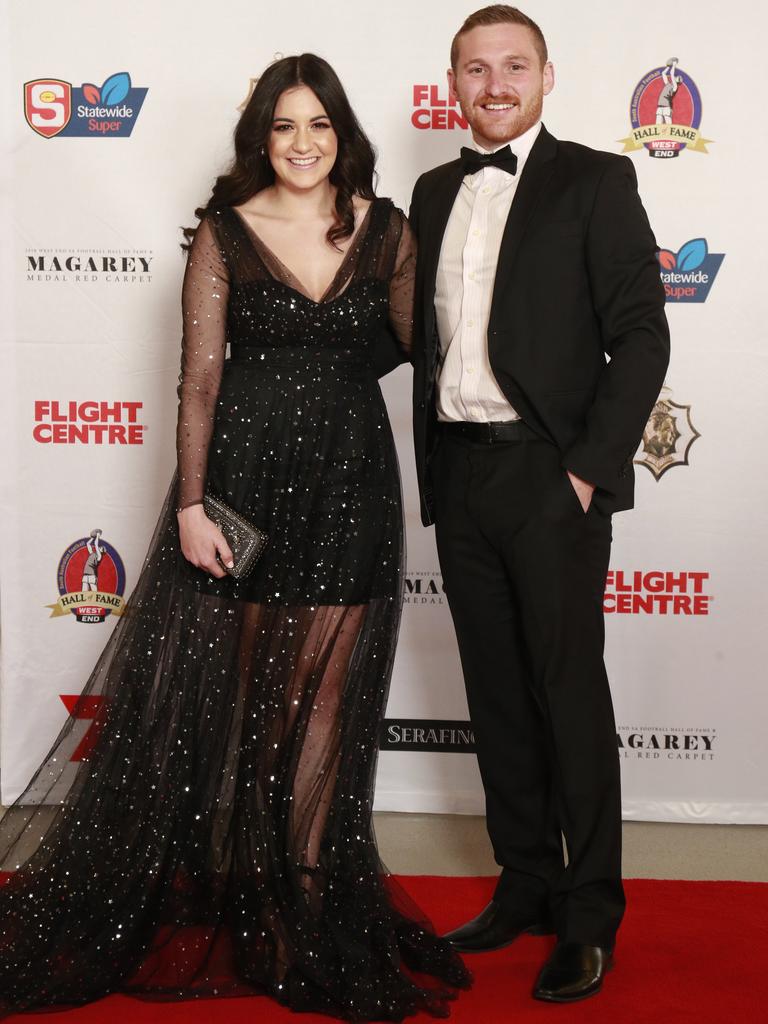 Alexa Vozzo wearing Nasreen Jawad and Jarrod Schiller pose for a picture on the red carpet at Adelaide Oval in North Adelaide, for the Magarey Medal, Monday, September 9, 2019. Picture: Matt Loxton