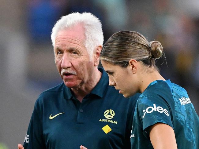 GOLD COAST, AUSTRALIA - DECEMBER 01: Tom Sermanni, Interim Head Coach of Australia speaks to Tameka Yallop, Emily van Egmond and Kyra Cooney-Cross of Australia during warm up prior to  the International Friendly match between the Matildas and Brazil at Cbus Super Stadium on December 01, 2024 in Gold Coast, Australia. (Photo by Bradley Kanaris/Getty Images)