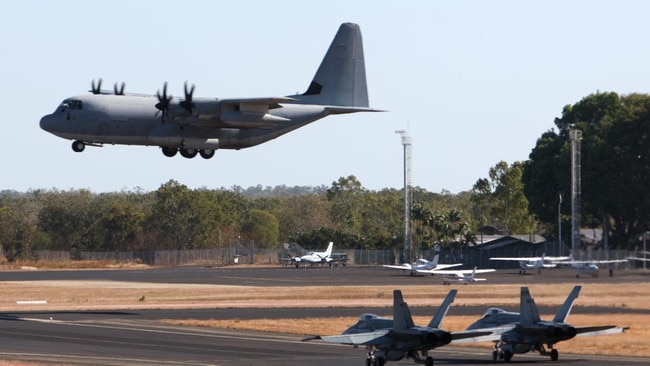 Two F/A-18s hold short while a United States Marine Corps KC-130 tanker lands at RAAF Base Tindal