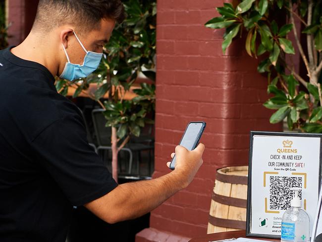 PERTH, AUSTRALIA - FEBRUARY 05: A customer scans the SafeWA QR code before entering the Queens Hotel on February 05, 2021 in Perth, Australia. Western Australia's COVID-19 lockdown restrictions will ease from 6pm today after no new community coronavirus cases were recorded in the last week. Face masks will remain compulsory in public and at work for another eight days in Perth and Peel once the lockdown ends. The five-day lockdown introduced across the Perth, Peel and South West regions of Western Australia on Sunday 31 January following the discovery of a positive community COVID-19 case in a worker from a quarantine hotel facility. (Photo by Stefan Gosatti/Getty Images)