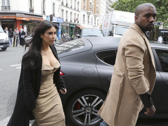 Kim Kardashian and U.S. rap singer Kanye West arrive at a luxury shop in Paris.