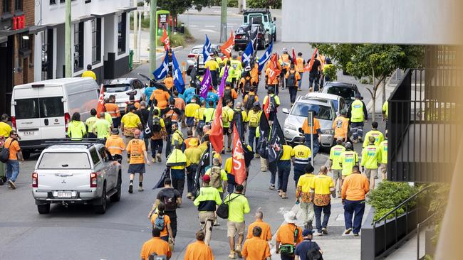 CFMEU members walk down Stratton Street in Newstead, on their way to William Street to demand the resignation of long-time Department of Transport and Main Roads Director-General Neil Scales. Picture: Supplied