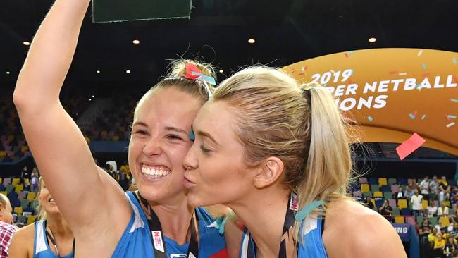 Paige Hadley (left) and Helen Housby (right) celebrates winning the Super Netball title last season.