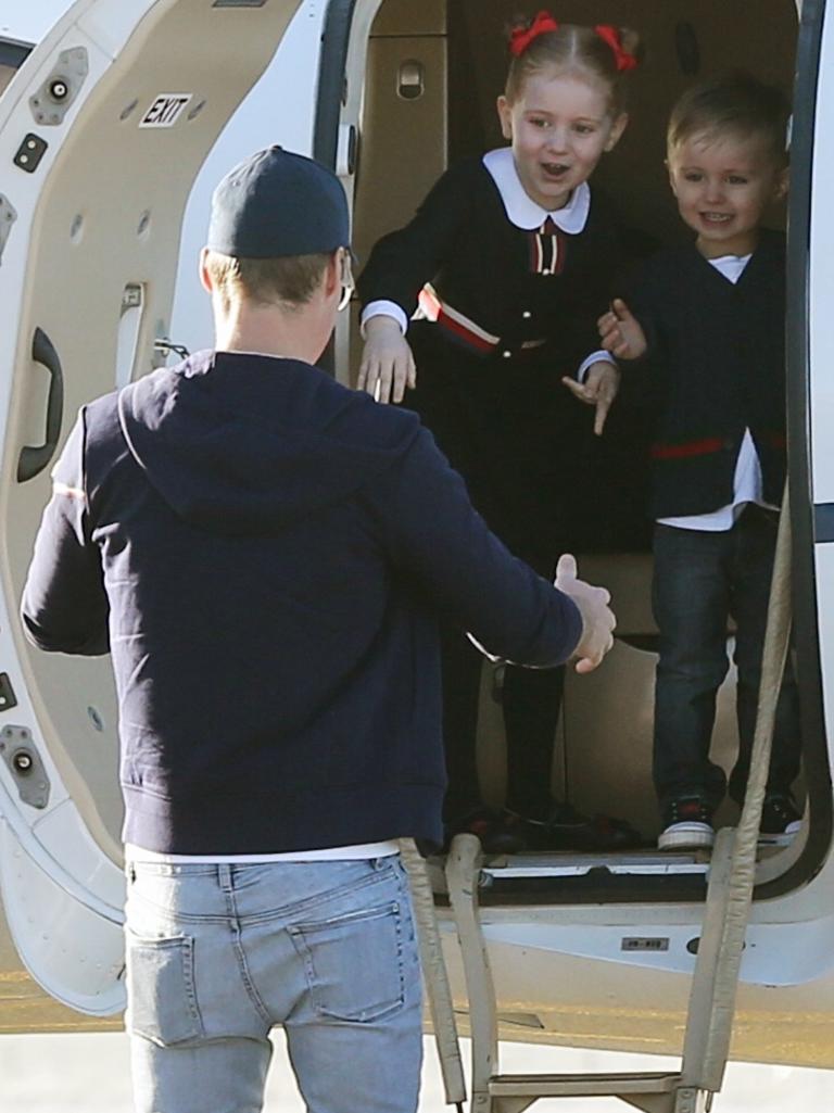 Oliver Curtis greets his children in the tarmac in their private jet. PR queen Roxy Jacenko and children at Cooma Airport to pick her husband Oliver Curtis after being released after serving time for insider traiding at Cooma Correctional Centre. Pic Stephen Cooper