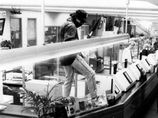 Binse leaps onto the counter at a Commonwealth Bank heist in Sydney in 1992.