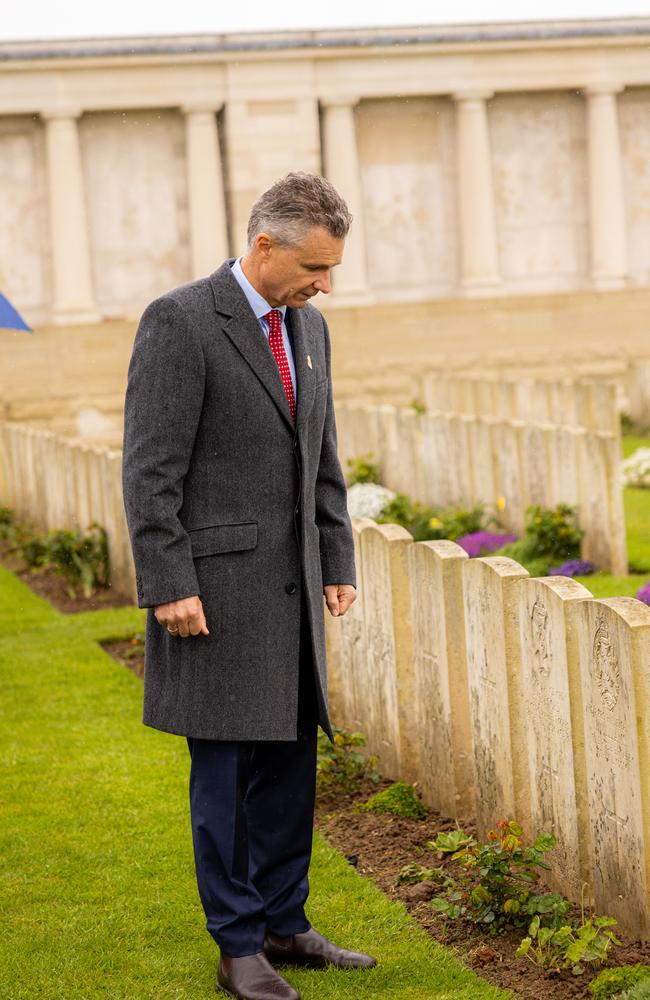 ‘Greater appreciation of the sacrifice’ ... Matt Thistlethwaite in a reflective moment at Pozieres British Cemetery during the launch of the Legacy Centenary Torch Relay 2023, presented by Defence Health, on Sunday. Credit: Callum Smith